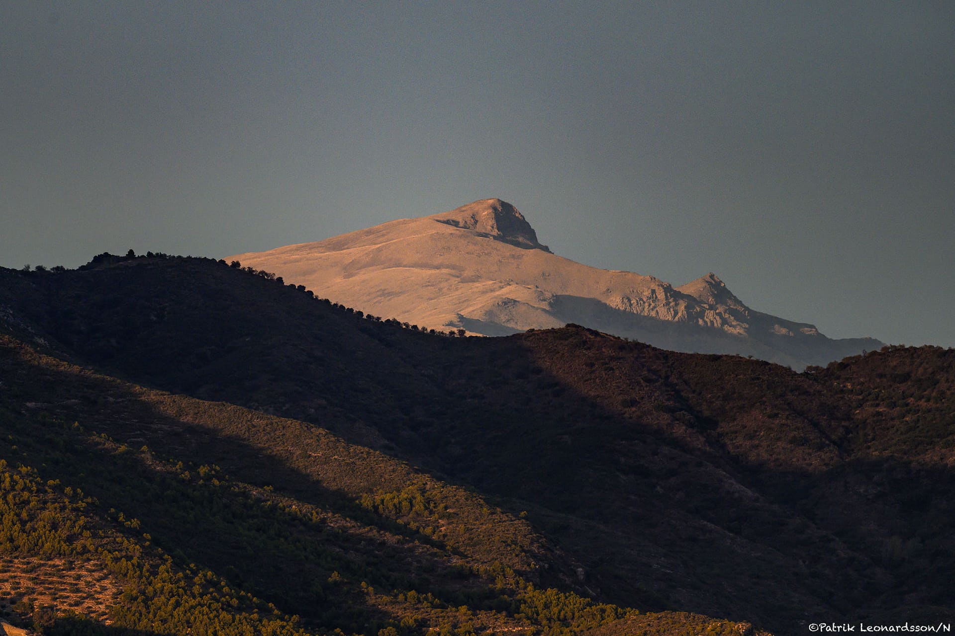 The Sierra Nevada's peak catching the day's last light.